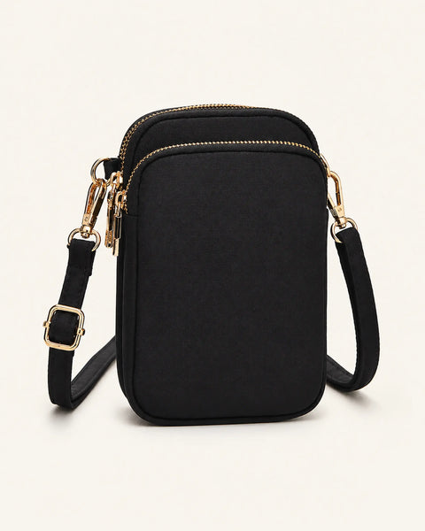 Élyra Crossbody-Tasche in Schwarz als Freisteller auf warmweißem Hintergrund.